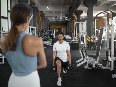 woman-helping-man-gym